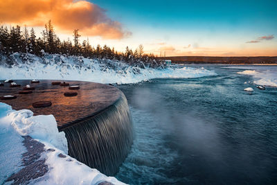 Frozen lake against sky during winter