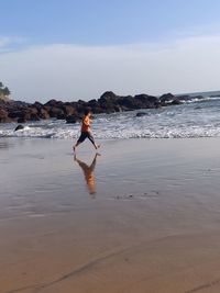 Full length of man on beach against sky