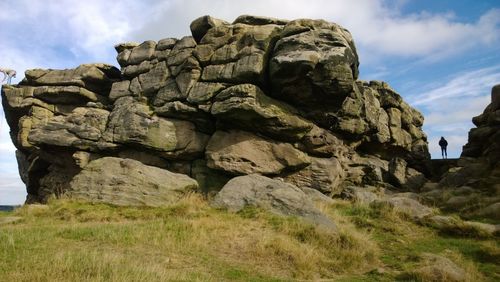 Low angle view of rock formation against sky