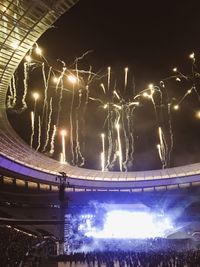 Low angle view of illuminated lights against sky at night