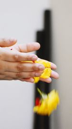 Close-up of hand holding yellow cake