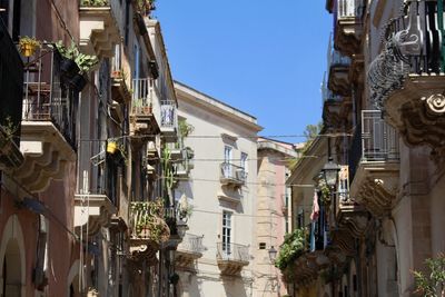 Low angle view of buildings in town against sky