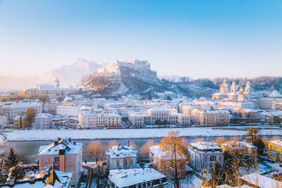 Snowcapped townscape against clear sky