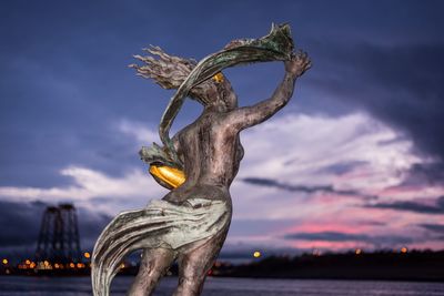 Low angle view of statue against sky