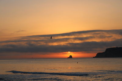 Scenic view of sea against orange sky