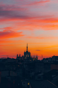 View of buildings in city during sunset