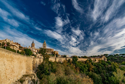 Buildings against cloudy sky