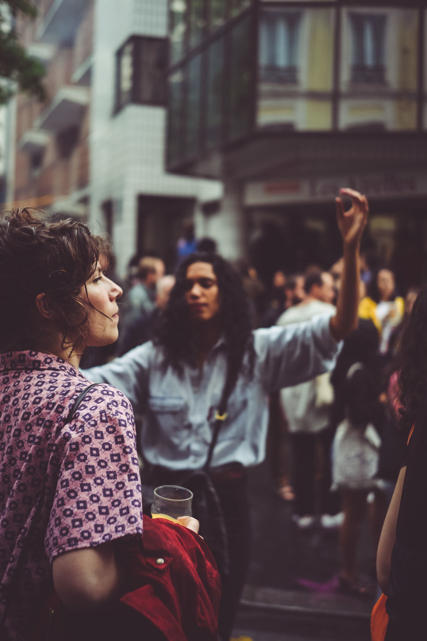 GROUP OF PEOPLE STANDING ON STREET