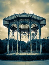 Low angle view of bridge against cloudy sky