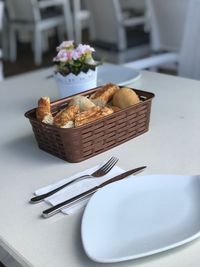 Close-up of fresh bread in basket on table