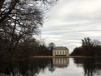 Lake by building against sky
