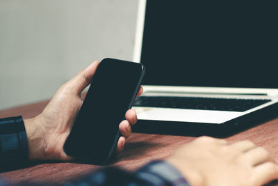 Midsection of man using mobile phone