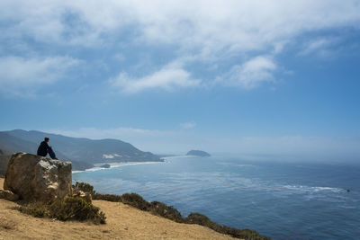 Man looking at sea against sky
