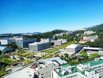 High angle view of buildings against blue sky