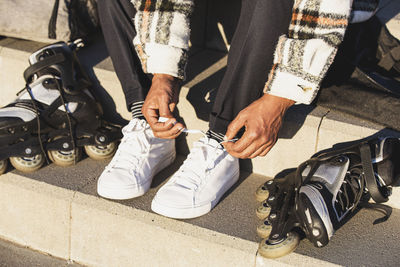 Close up of man's feet preparing the inline skates. man preparing to skate person