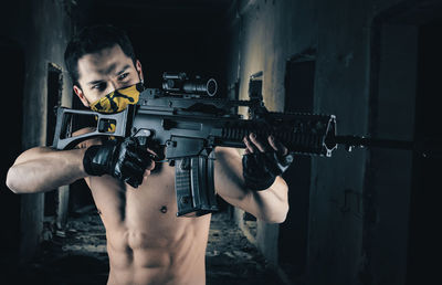 Young man holding camera at home