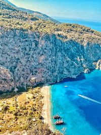 High angle view of sea and mountains against sky