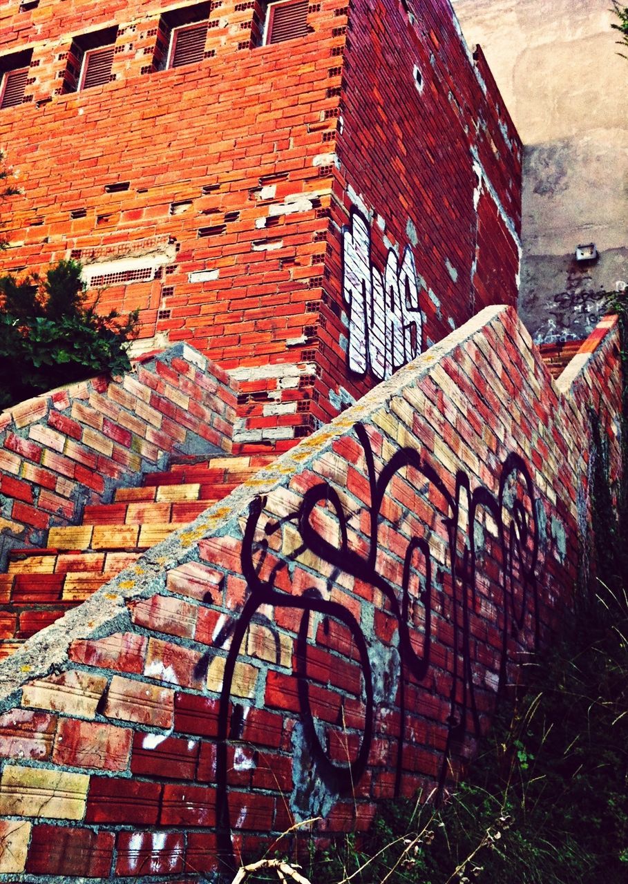 architecture, building exterior, built structure, brick wall, wall - building feature, graffiti, brick, building, window, outdoors, full frame, wall, residential structure, day, residential building, old, low angle view, no people, stone wall, pattern