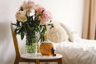 Close-up of flowers in vase on table at home