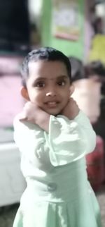 Portrait of smiling girl standing outdoors