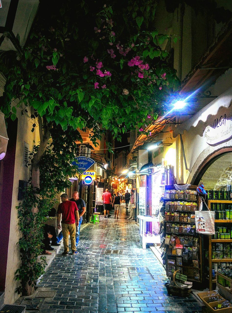 VIEW OF FOOTPATH IN CITY AT NIGHT
