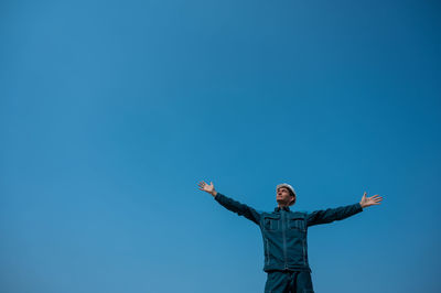 Low angle view of statue against clear blue sky