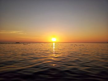 Scenic view of sea against romantic sky at sunset