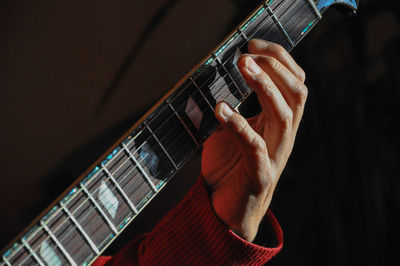 Cropped image of man playing guitar