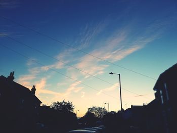 Low angle view of silhouette street against sky at sunset