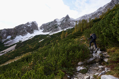 Rear view of people hiking on snowcapped mountain in triglav national park in slovenia