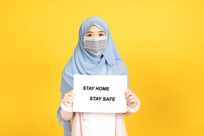 Portrait of person wearing mask against white background