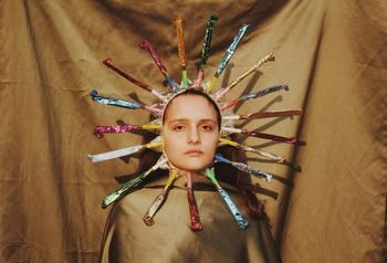 Portrait of young woman wearing antique colorful headwear