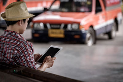 Midsection of man using mobile phone