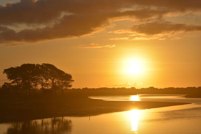 Scenic view of lake against sky during sunset