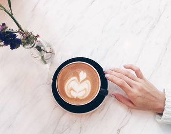 Close-up of woman holding coffee