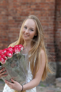 Close-up of woman holding red flower