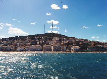 View of town by sea against sky