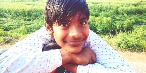 Portrait of smiling boy on field