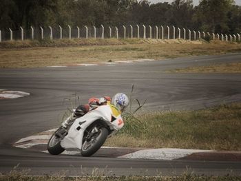 Man riding motorcycle on road