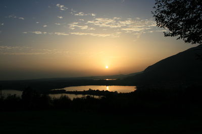 Scenic view of silhouette mountains against sky during sunset