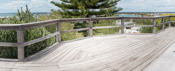 High angle view of footpath by railing against sky