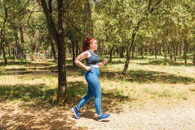 Full length of young woman standing on field