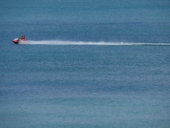 People jet skiing in sea