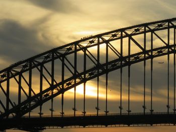 Sydney harbor bridge against sky during sunset