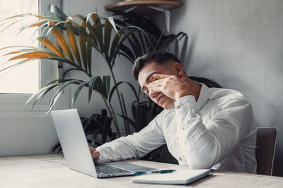 Young man using laptop at home