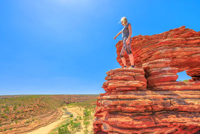 Woman standing on rock formation at kalbarri national park 