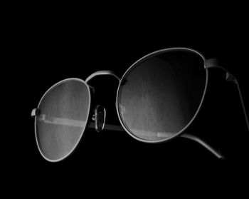 Close-up of sunglasses against black background