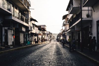 Street amidst buildings against sky