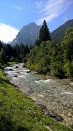 Scenic view of waterfall against sky