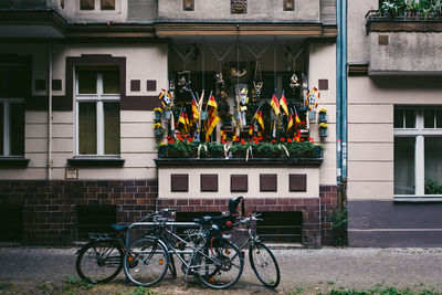 Bicycles parked outside building with german flags in balcony